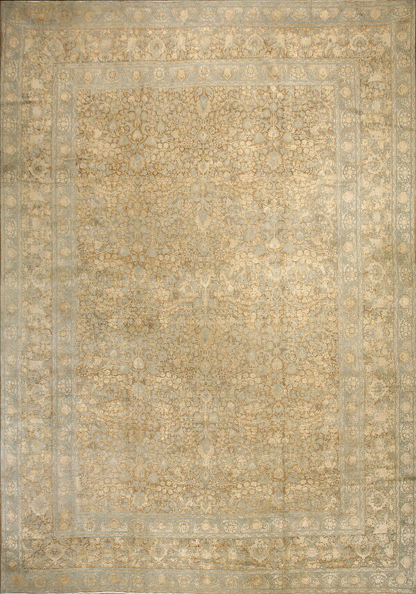 Traditional rug with a dense botanical pattern in tan, light gold, and pale blue colors.