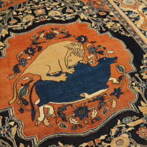 Detailed rust and navy rug featuring a central medallion depicting a lion attacking a blue bull.