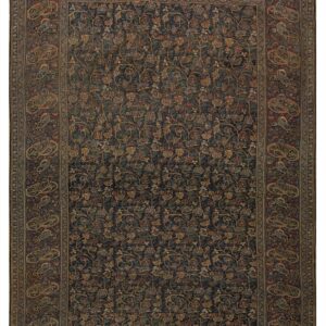 Dark navy rug with intricate all-over floral pattern and a wide reddish-burgundy paisley border.