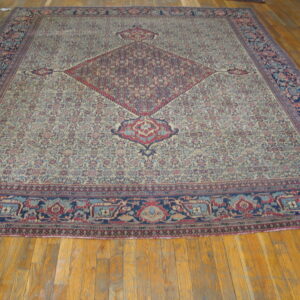 Low-pile rug with a cream field, dense floral design, central red medallion, and wide blue border.