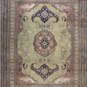 Pale green rug with rose, navy, and beige colors, featuring a central medallion and various animal figures.