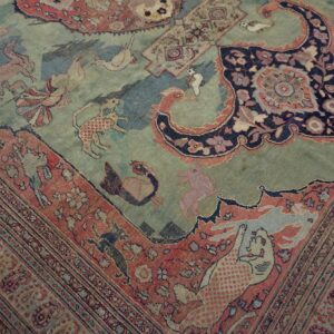Muted low-pile rug with a pictorial design featuring stylized animals on a blue and green field.