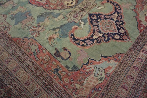 Muted low-pile rug with a pictorial design featuring stylized animals on a blue and green field.