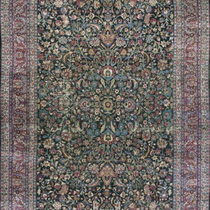 Dark teal rug with intricate red, blue, and gold floral patterns and a wide multi-banded border.