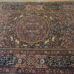 Low-pile, elaborate navy and burgundy area rug featuring animal figures and intricate scripted borders.