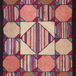 A colorful geometric hooked rug with a central diamond pattern surrounded by solid and vertically striped blocks.
