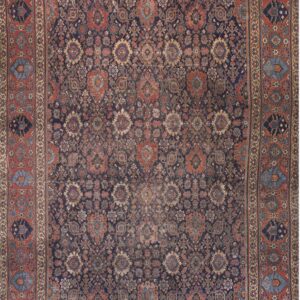 Low-pile rug with a dense navy blue and rust red traditional pattern of repeating floral and medallion motifs.