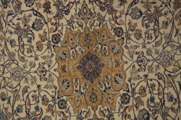 Cream rug with detailed traditional floral motifs in blue, tan, and dark brown accents.