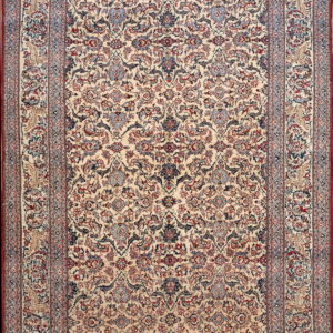 Cream rug with a detailed floral design and complex borders in red, navy, and light blue.