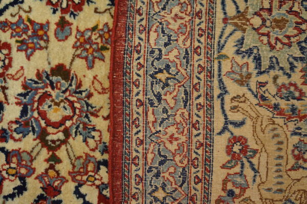 Intricate floral and geometric patterns in red, navy blue, and light blue against a beige background.