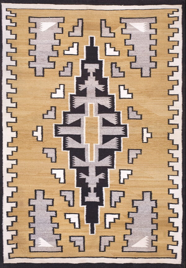 A rug featuring a geometric stepped pattern in black, gray, and white on a mustard yellow field.