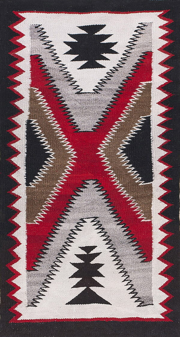 Black, red, white, gray, and brown flatweave rug with a large central geometric x pattern.