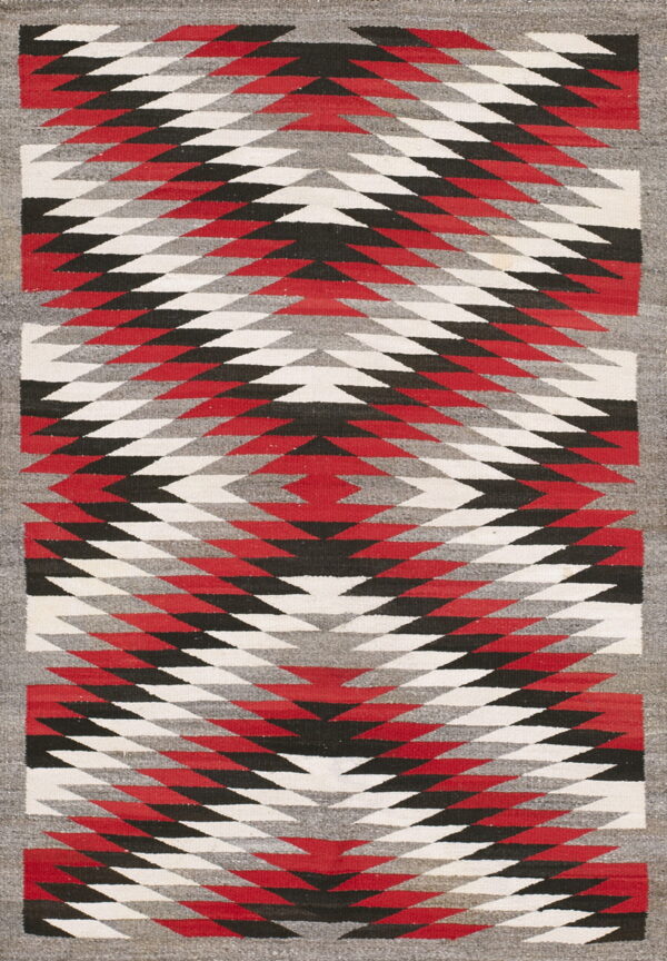 Bold tribal geometric pattern antique native american flat weave navajo rug 1 Flat woven rug featuring bold red, black, gray, and white geometric zigzag patterns within a gray border.