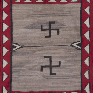 Gray flat-woven rug with a red triangular border surrounding two black angular symbols.