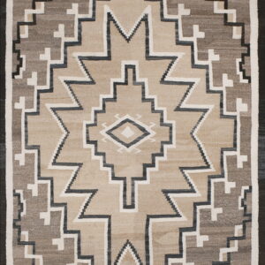 Flatwoven geometric rug featuring large stepped shapes in beige, gray, white, and black.