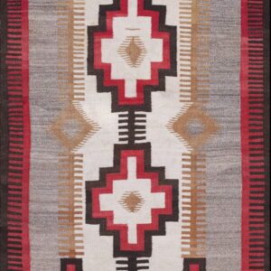 Flatweave runner rug featuring strong geometric patterns in red, gray, black, and white.