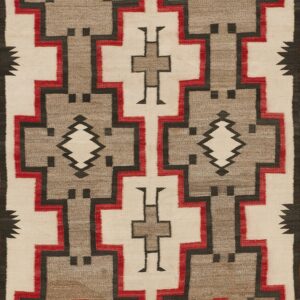 Geometric flat weave rug in cream, gray, red, and black with large interlocking stepped designs.