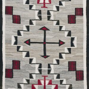Gray flatweave rug featuring serrated, stepped, and cross motifs in black, white, and deep red.