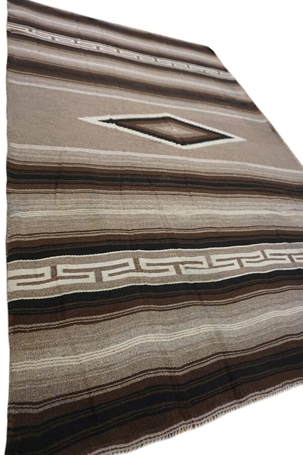 Brown and tan striped rug with a central diamond shape and repeating geometric border pattern.