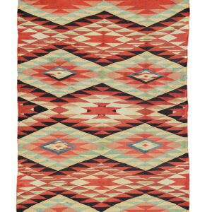 Red, black, and teal geometric flatweave rug with prominent diamond and triangle patterns.