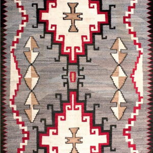 Geometric flatweave rug featuring a gray field with symmetrical patterns in white, red, black, and tan.