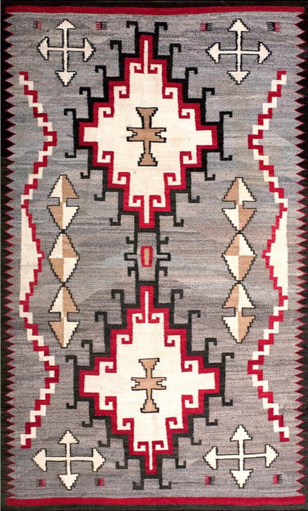 Geometric flatweave rug featuring a gray field with symmetrical patterns in white, red, black, and tan.