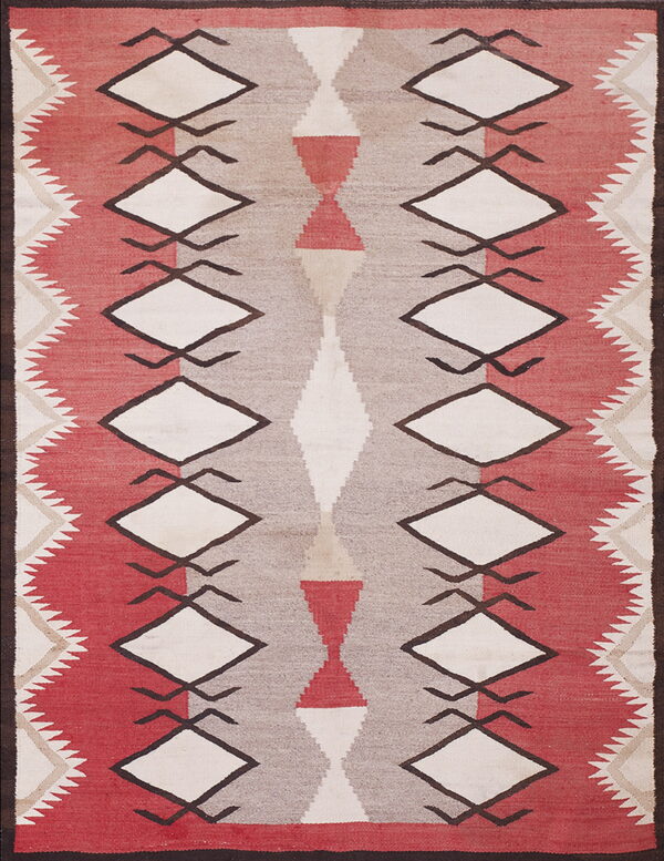 Geometric flatweave rug in red, taupe, and cream, featuring prominent diamond and hourglass shapes.