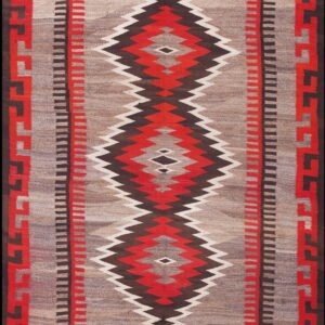 A flatwoven rug with a gray field, serrated red and brown diamonds, and a geometric key border.