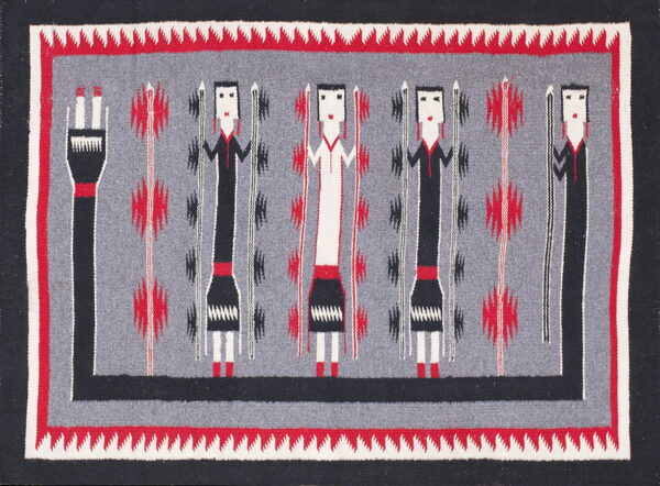 Black, red, and gray woven rug with abstract figures and a serrated border design.