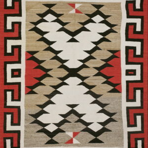 Geometric rug with red, black, and cream meander borders framing a flat-woven field of serrated diamonds.
