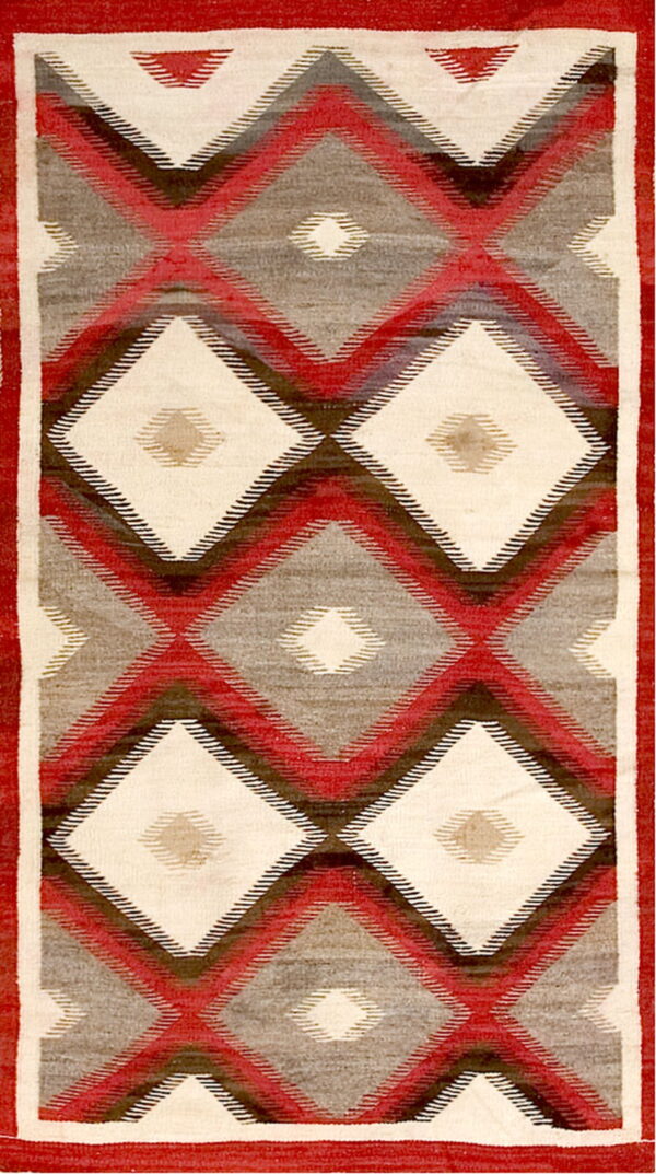 Geometric flatweave rug featuring repeating diamonds in cream, red, gray, and dark brown within a red border.