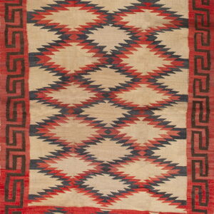 Flatwoven rug in red, tan, and dark gray with geometric diamond patterns and a fret border design.