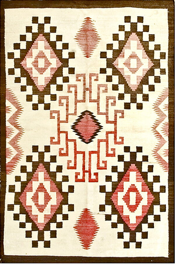 Cream flatweave rug with dark brown, red, and pink geometric diamonds and central interlocking key pattern.