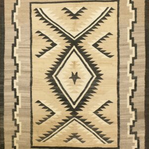 A flatweave rug featuring a central diamond and geometric pattern in beige, gray, and black.