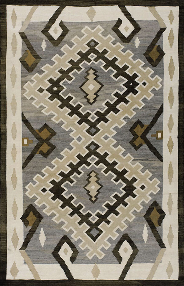 Gray flatweave rug with dark brown, cream, and beige interlocking geometric diamond motifs.