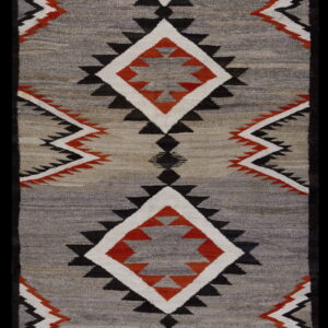 Flatweave rug featuring black, white, and orange geometric diamonds on a heathered gray field with a black border.