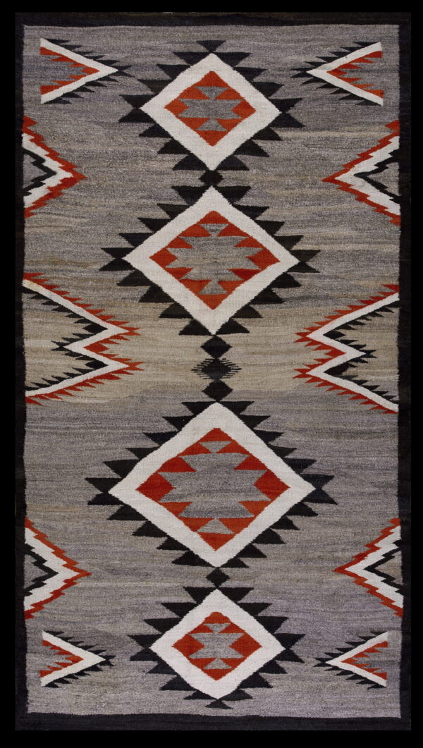 Flatweave rug featuring black, white, and orange geometric diamonds on a heathered gray field with a black border.