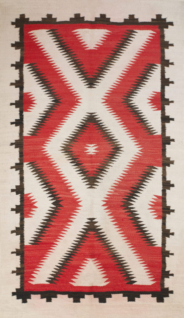 Vertical diamond pattern in red and dark brown on an off-white flatweave rug with a stepped border.