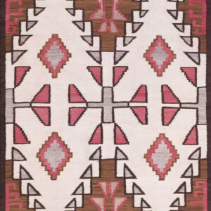 Cream flatweave rug with repeating geometric designs in brown, gray, and bright pink.