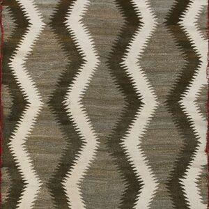 Flatweave textile with cream and dark serrated diamond motifs on a taupe background, framed by rust and white stripes.