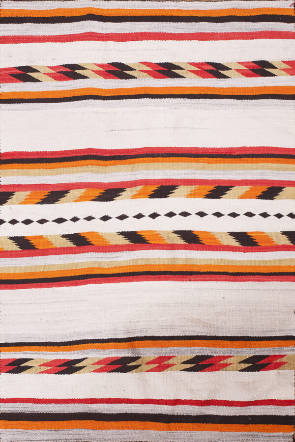 White flatweave rug featuring horizontal stripes with red, orange, black, and tan geometric designs.