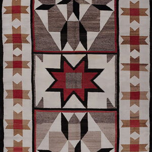 A runner rug featuring geometric star designs in red, black, white, and brown with a flatweave texture.