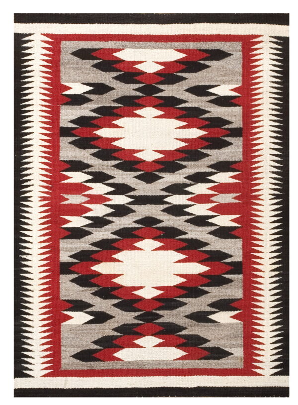 Black, red, gray, and white flatweave rug featuring a bold geometric diamond pattern.