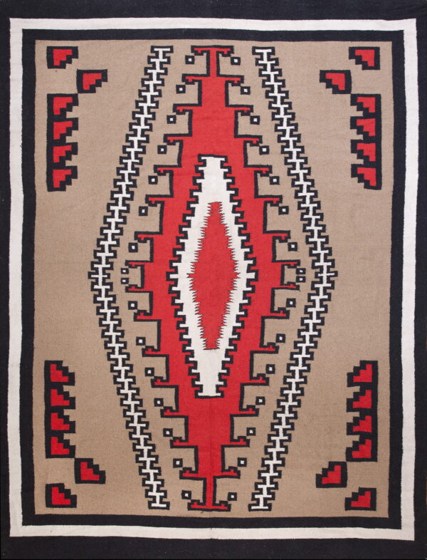 Tan rug with a central red and white stepped geometric medallion and black and white borders.
