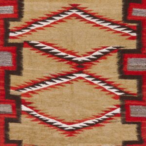 Tan low-pile rug featuring red, black, and white sawtooth diamonds and stepped geometric borders.