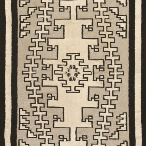 Black, gray, and cream flat-weave rug with interlocking geometric patterns and a large central cross motif.
