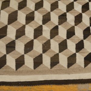 Geometric flatweave rug featuring interlocking cubic designs in shades of brown, taupe, and natural beige.
