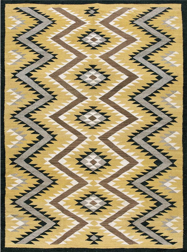 Mustard yellow rug with large brown, grey, white, and black serrated geometric diamond patterns.