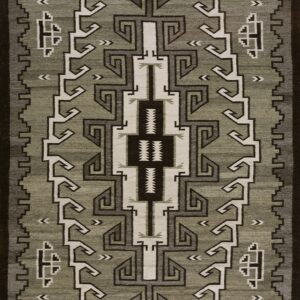 Low-pile rug with geometric fretwork and stepped patterns in sage green, dark brown, and cream.