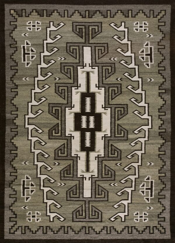 Low-pile rug with geometric fretwork and stepped patterns in sage green, dark brown, and cream.